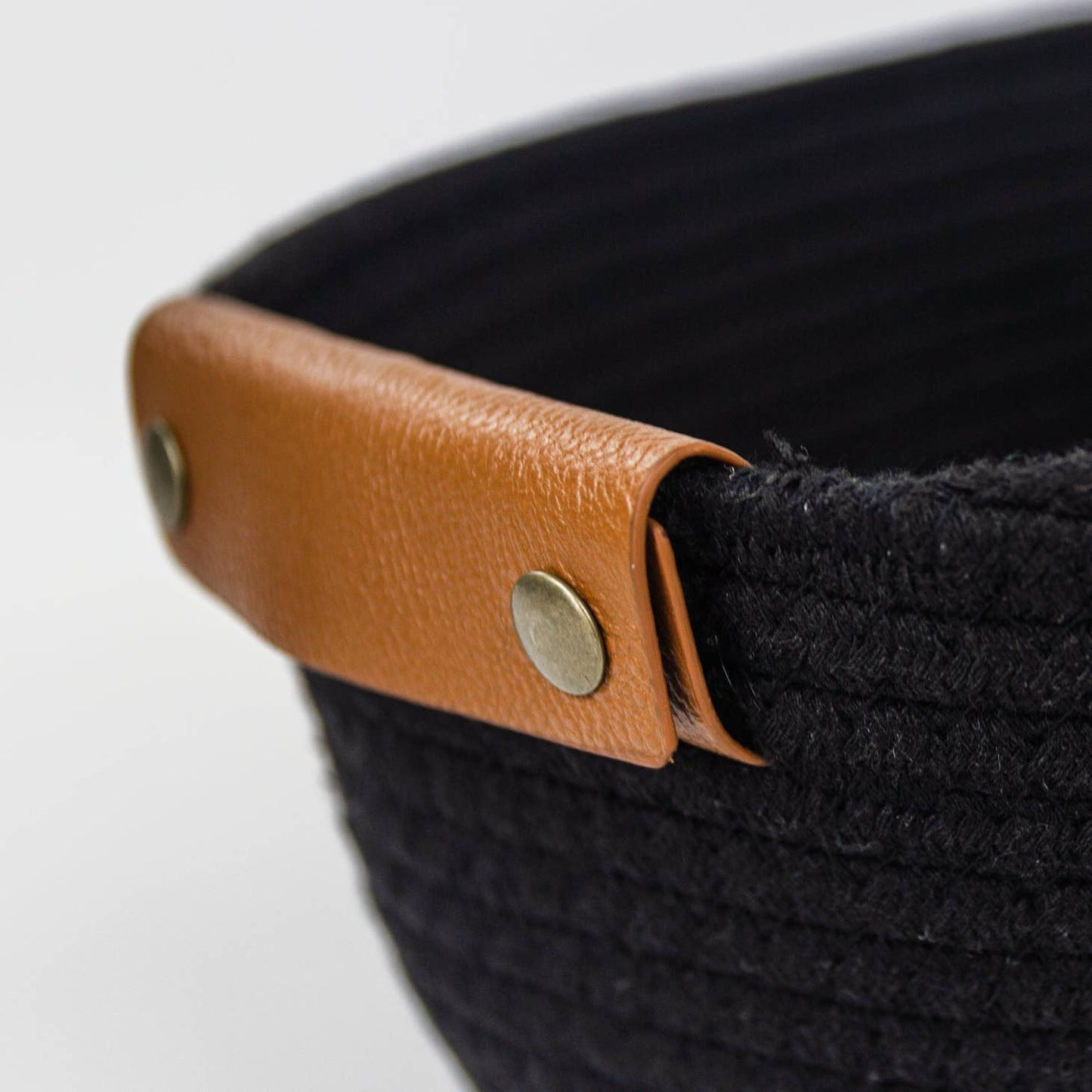 Woven storage basket with leather handles