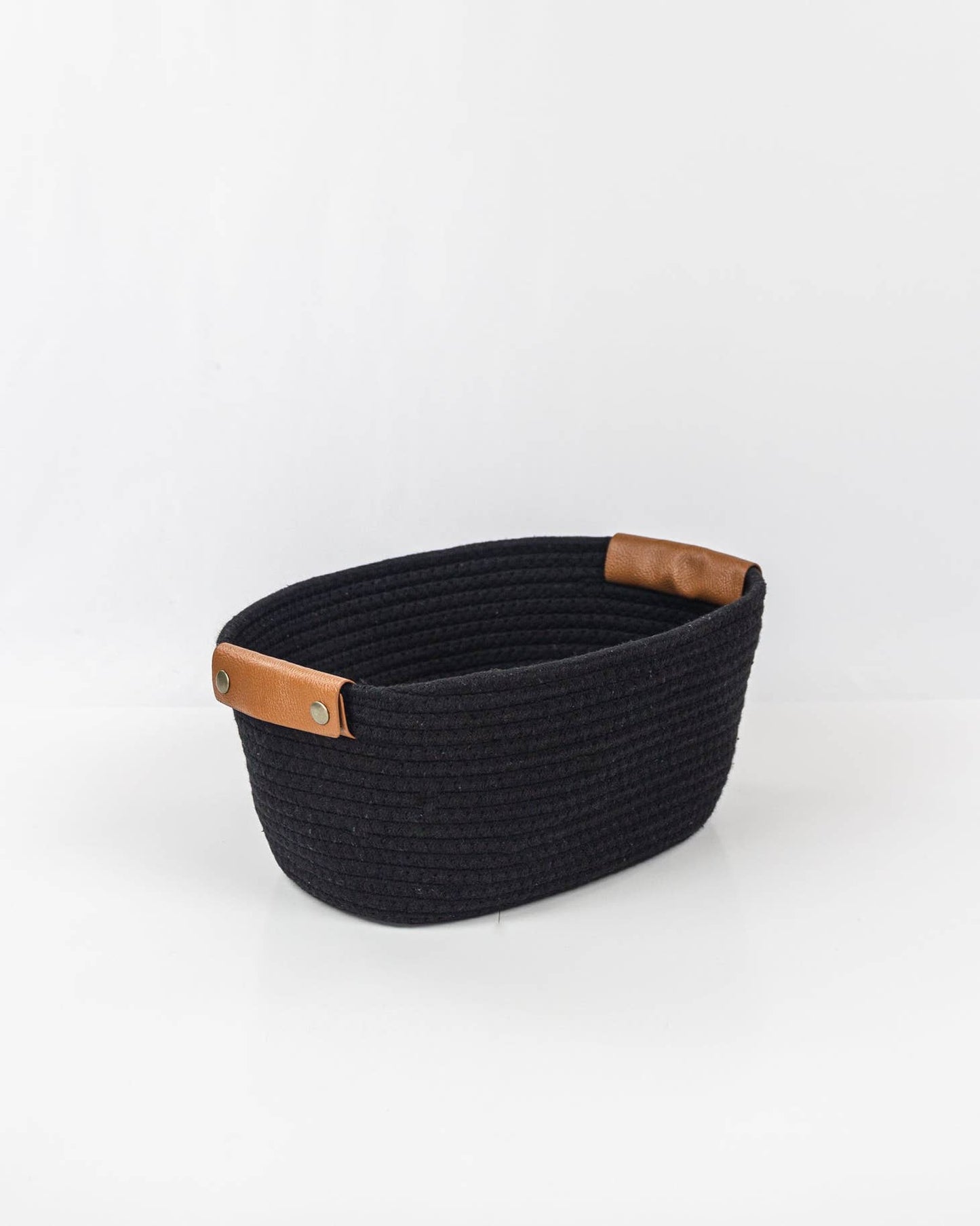 Woven storage basket with leather handles